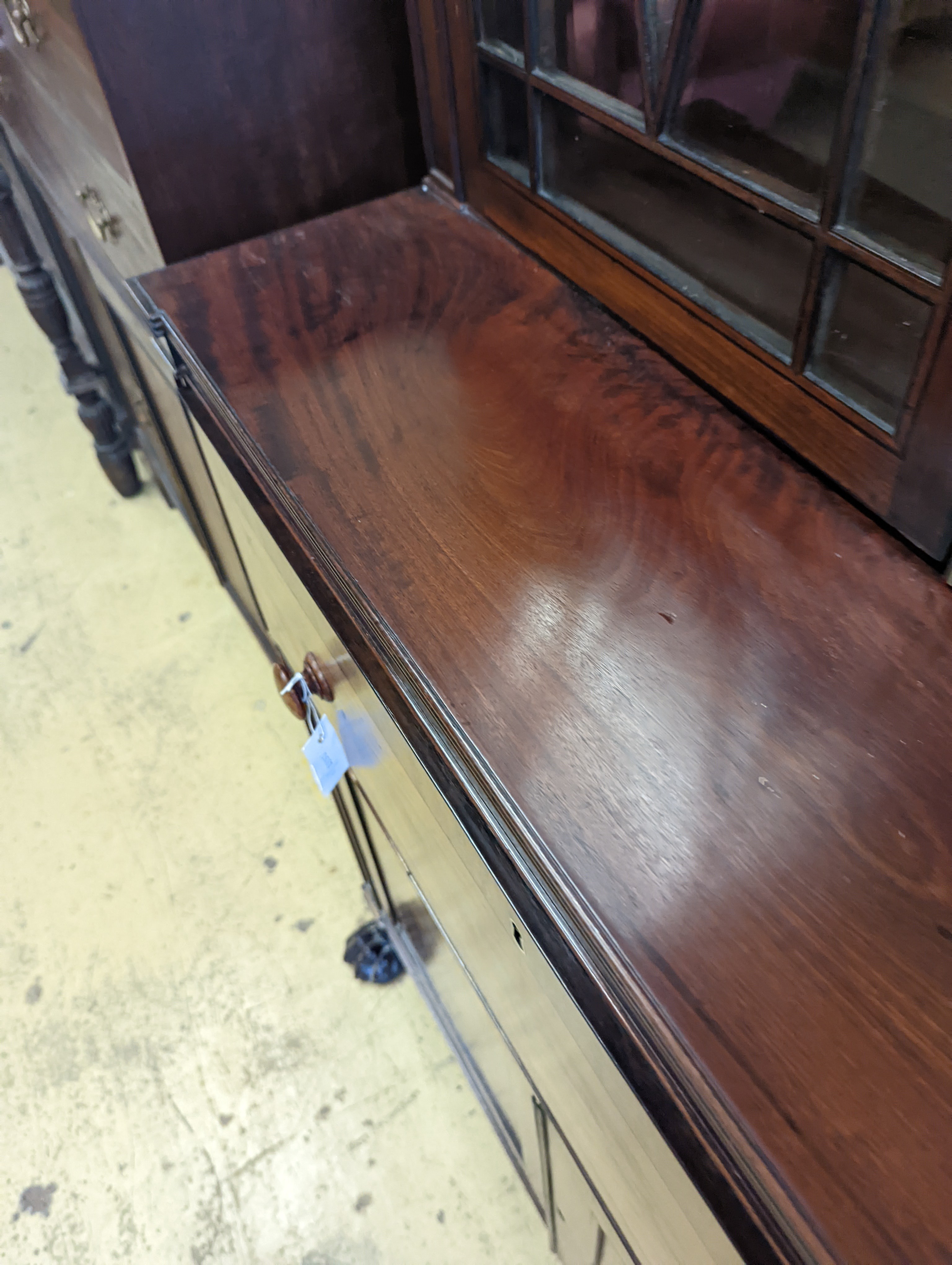 A Regency mahogany secretaire bookcase on lion paws feet, length 100cm, depth 56cm, height 216cm